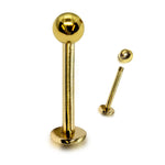 Gold lip ring with a ball on a white background