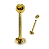 Gold lip ring with a ball on a white background