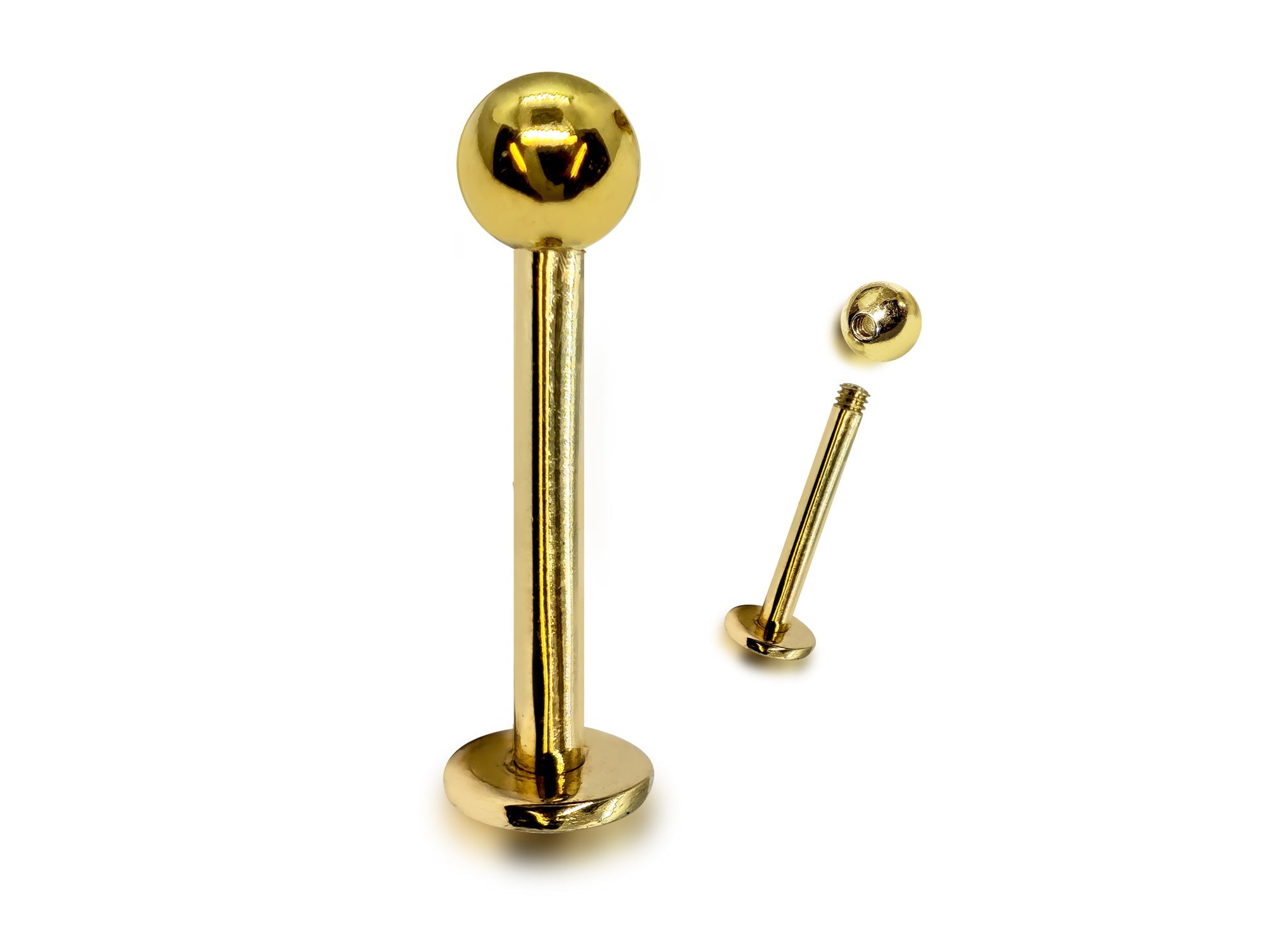 Gold lip ring with a ball on a white background